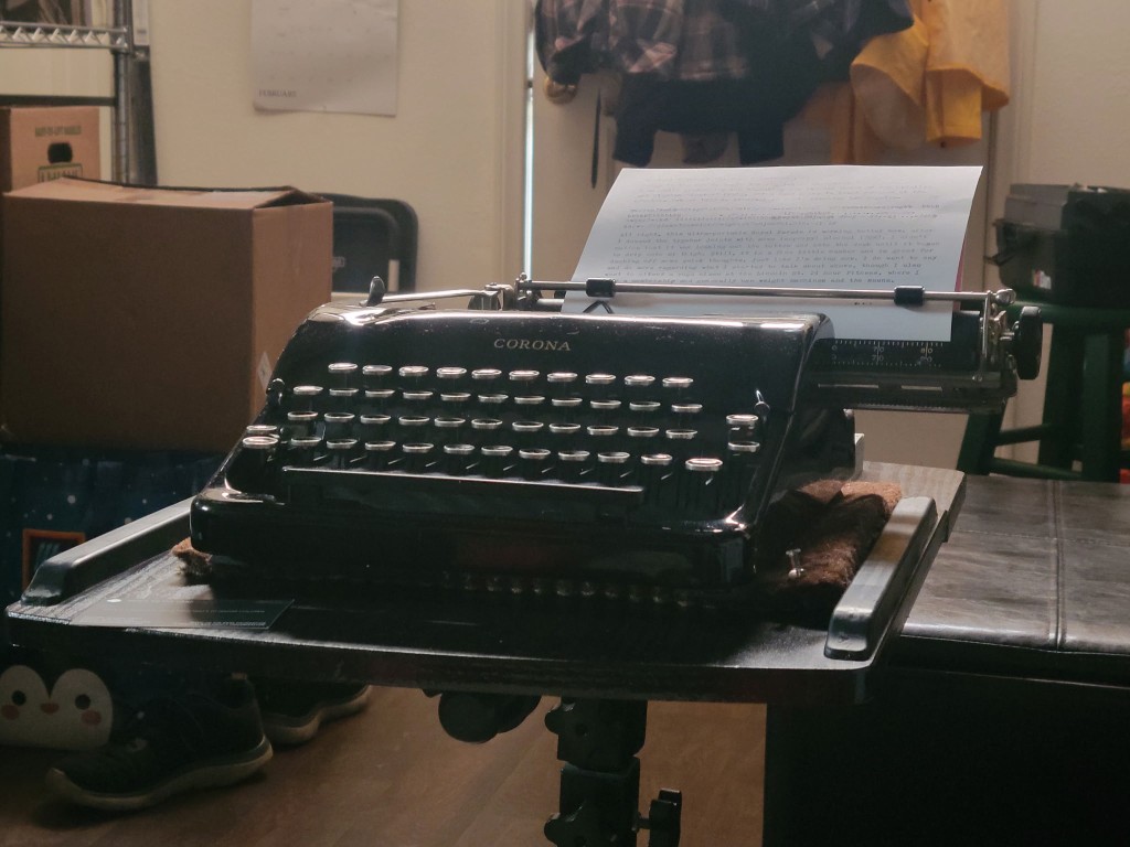 Black Corona typewriter with a typed page in the platen