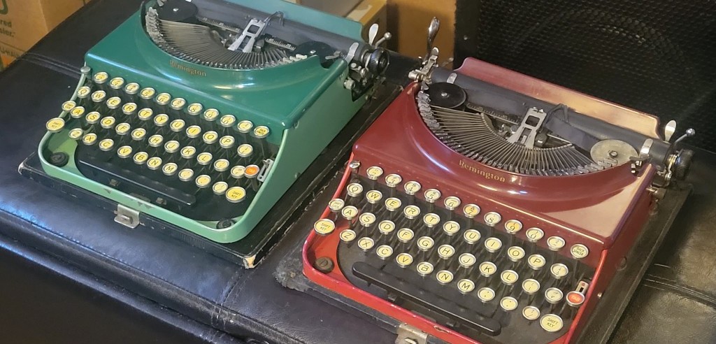 Green and red Remington typewriters side by side