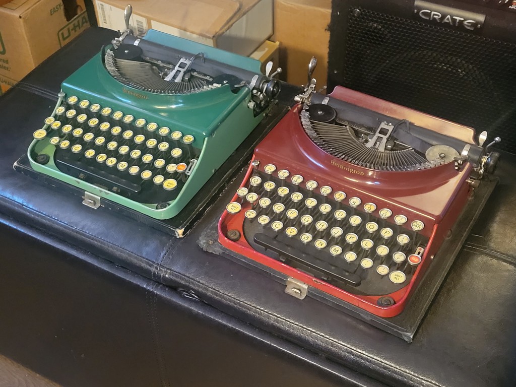 A green Remington and a red Remington typewriter side by side